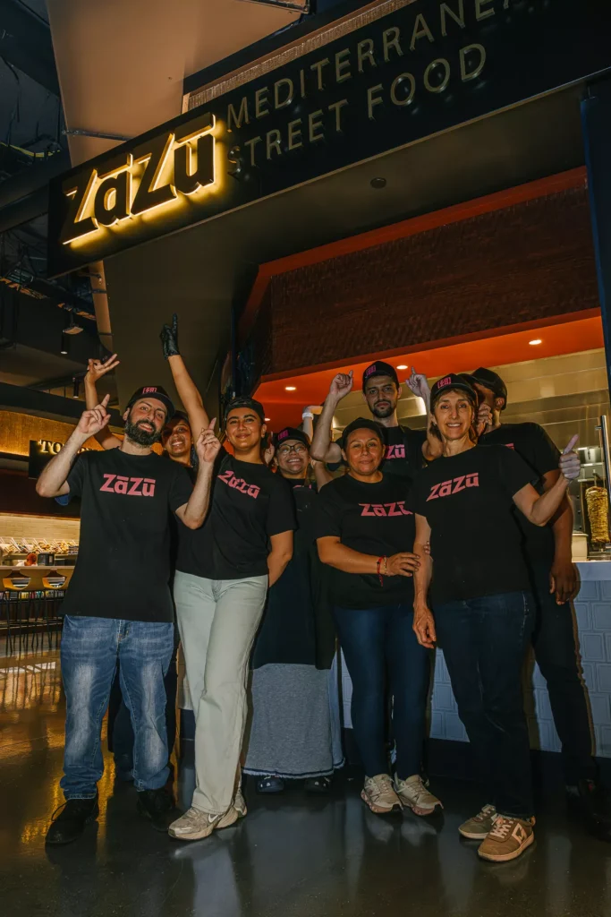 employees celebraing the setup of the new Zazu Mediterranean Street Food at Shavr hall NYC